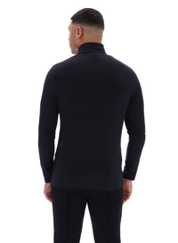Man wearing a black long-sleeve shirt and pants on a white background