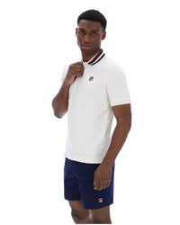Displays a model wearing the Gardenia 'FILA' branded Achille Heritage Tape Basic Polo