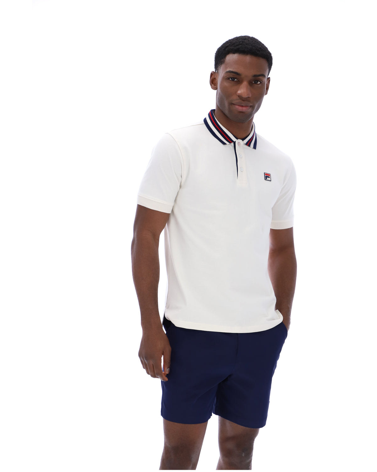 Displays a model wearing the Gardenia 'FILA' branded Achille Heritage Tape Basic Polo