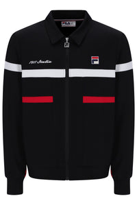 A black FILA track jacket with a zip-up front, featuring white stripes across the chest, red horizontal bands on the pockets, and the FILA logo on the left chest.