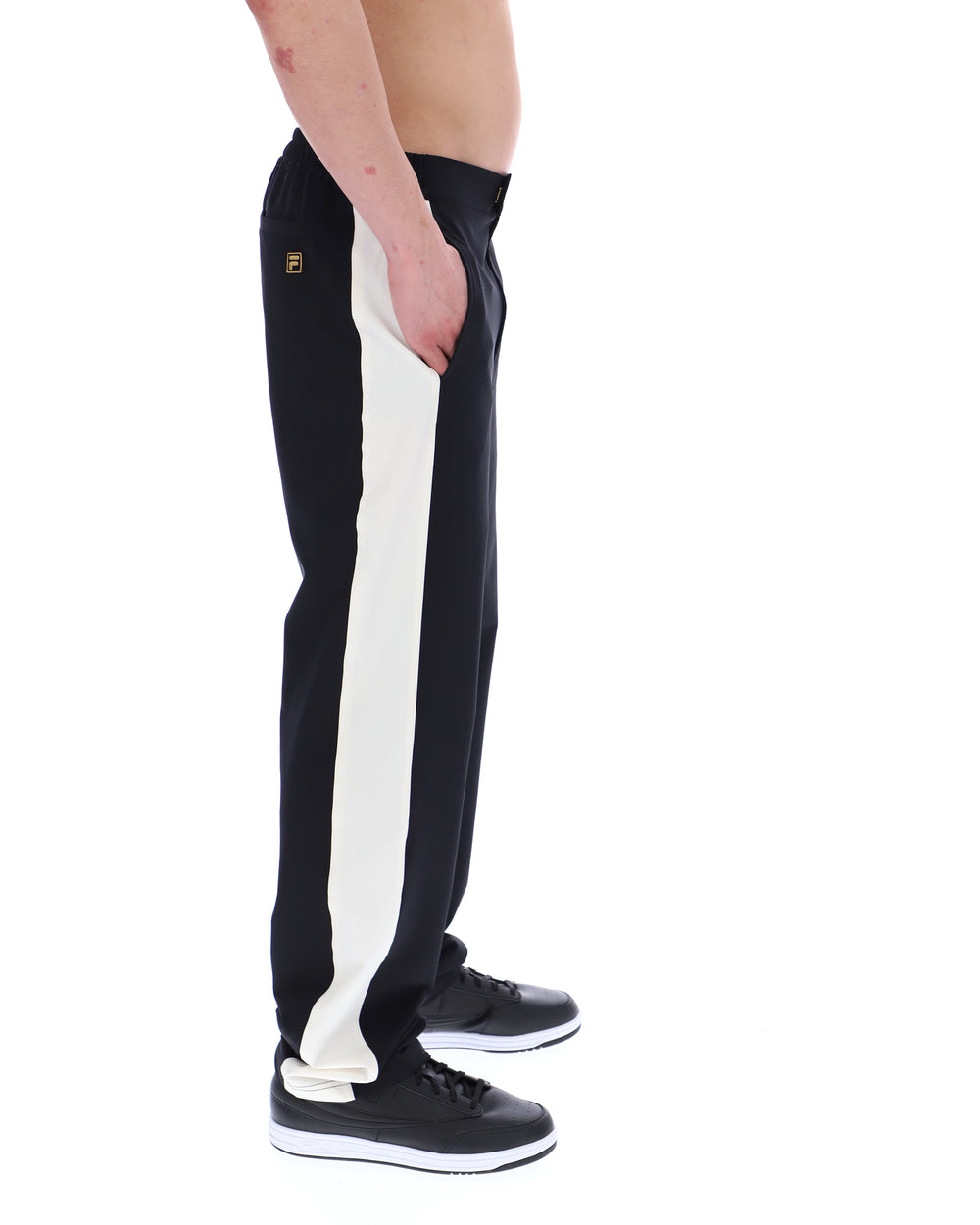 Black and white track pants with a brand logo on a white background