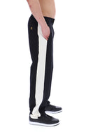 Black and white track pants with a brand logo on a white background