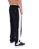 Black and white track pants with a brand logo on a white background