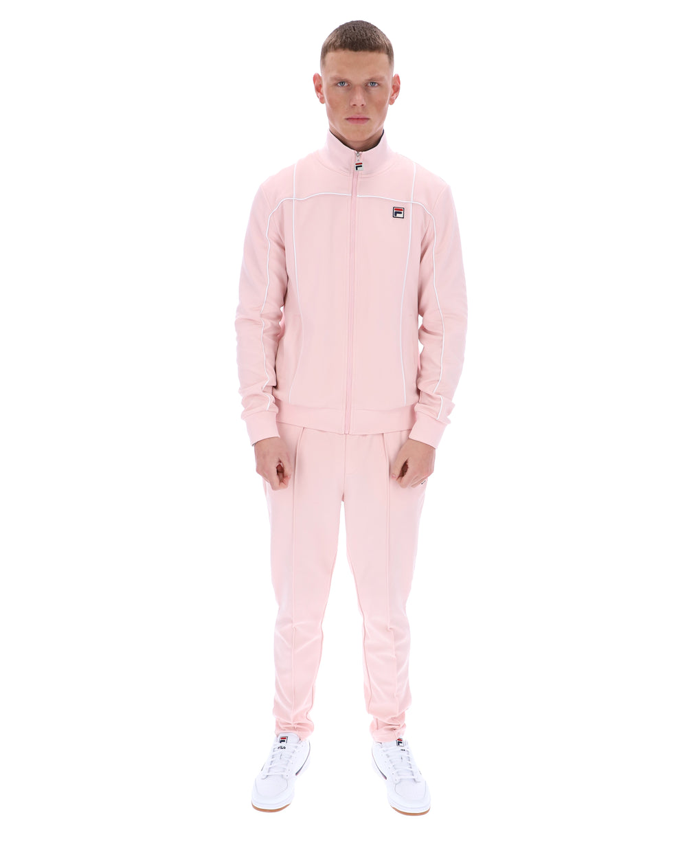 Man wearing a pink tracksuit on a white background