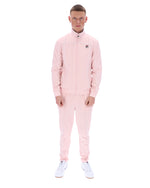 Man wearing a pink tracksuit on a white background