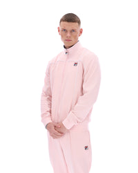 Person wearing a pink tracksuit with a brand logo on a white background