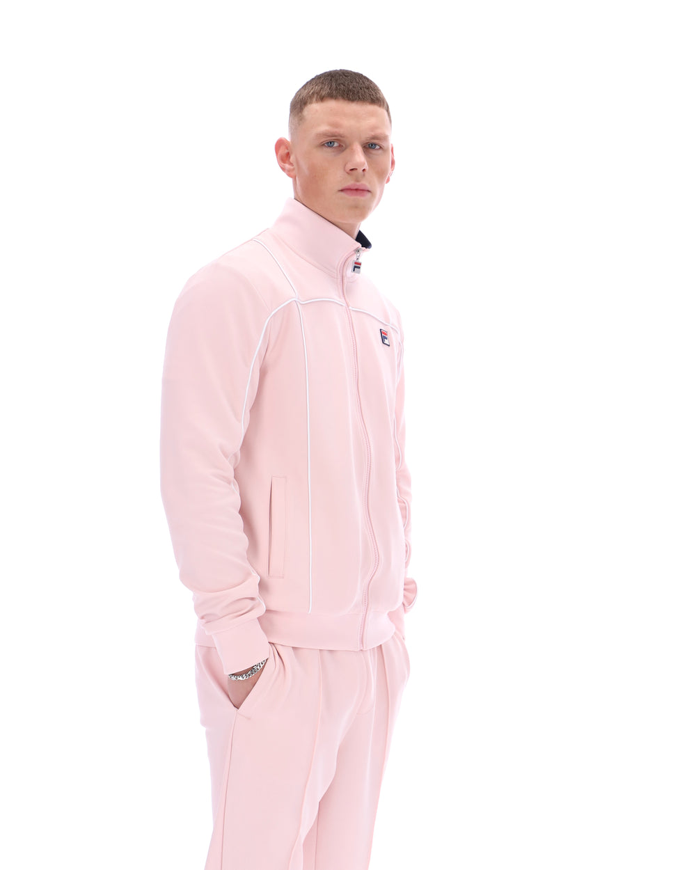 Man wearing a pink tracksuit on a white background