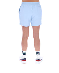 Light blue shorts worn by a person on a white background