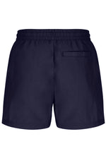 A person wearing black Artoni Swim Shorts with a drawstring waistband and the FILA logo on the leg, paired with white socks and grey sneakers.