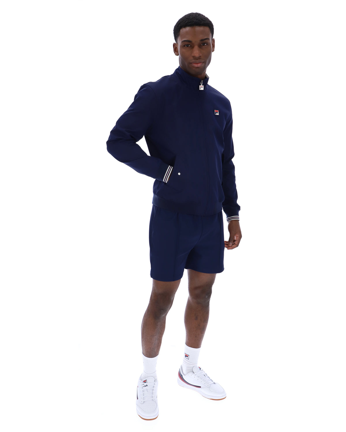 Displays a model wearing the Navy 'Fila' branded Arturo Coach Jacket