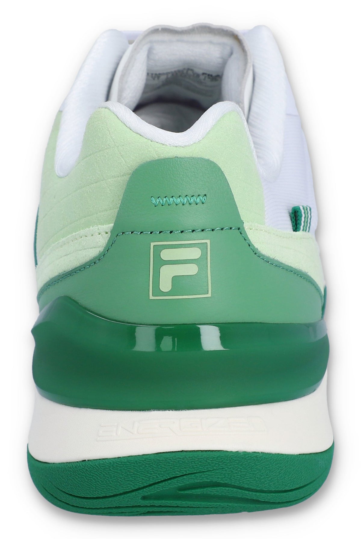 A white tennis trainer with green accents and the FILA logo on the heel.