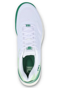 A white tennis trainer with green accents and the FILA logo on the tongue and insole.