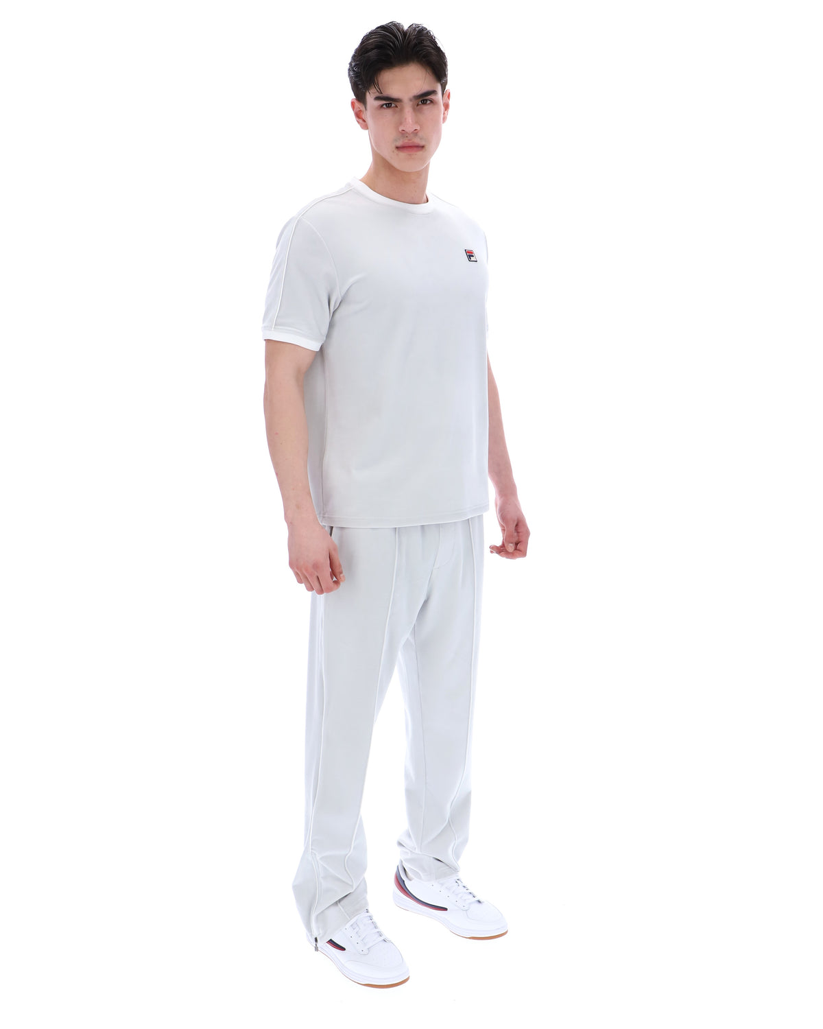 Person wearing a dawn blue t-shirt and pants on a white background