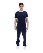 Man wearing a navy tracksuit with white accents on a white background