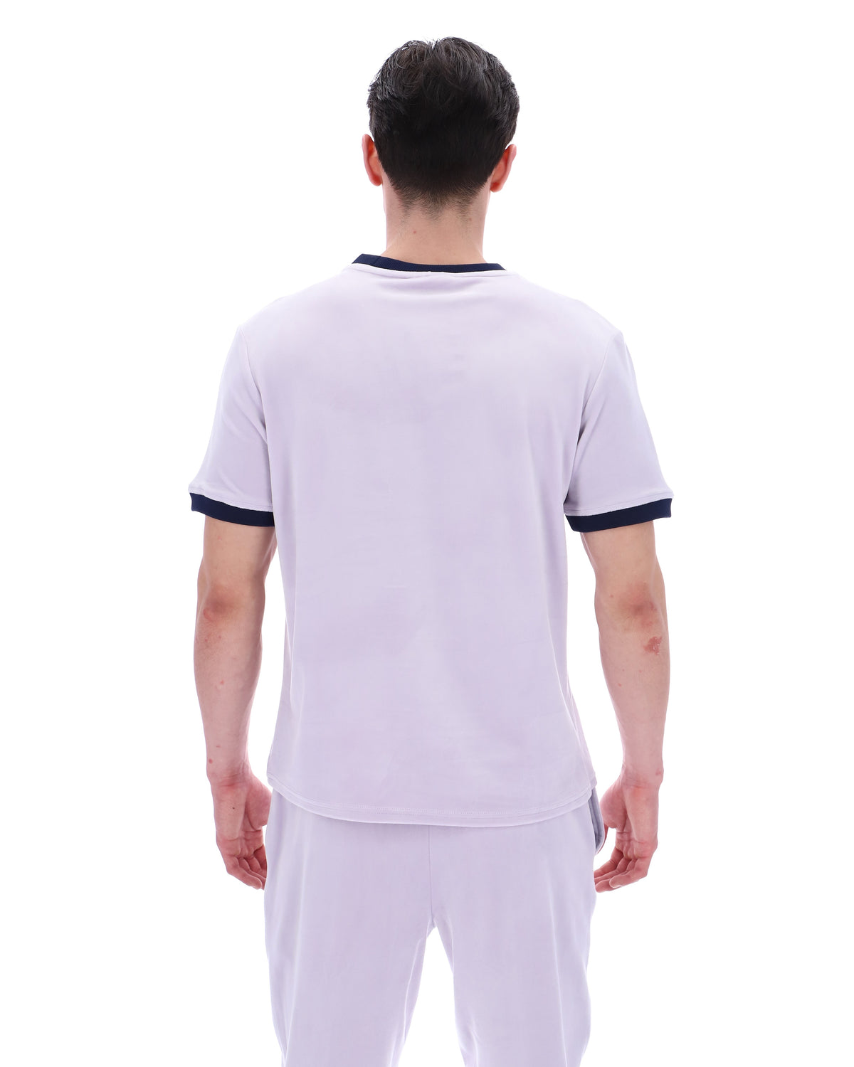 Person wearing a lilac t-shirt paired with matching joggers, on a white background