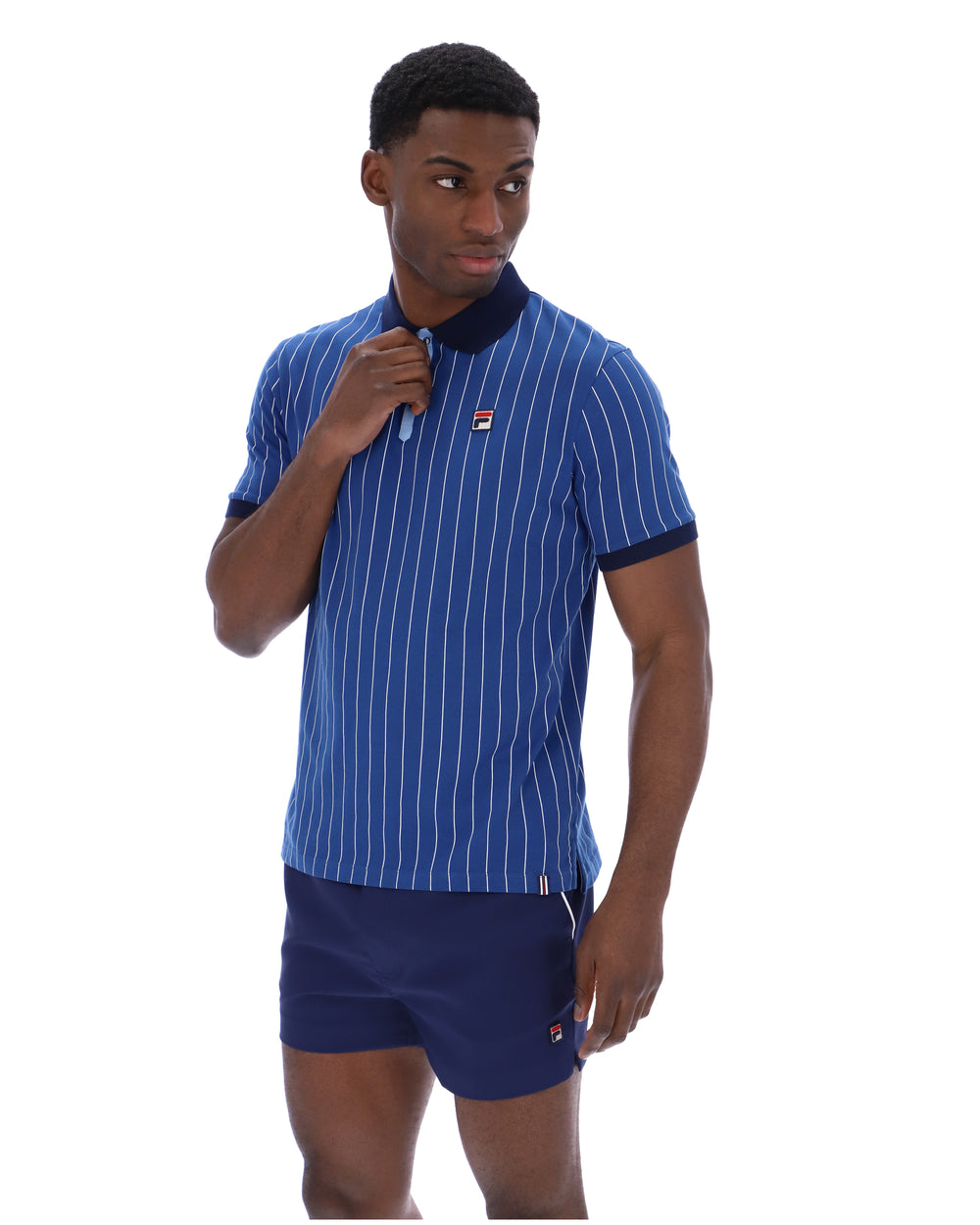 Man wearing a blue striped shirt and shorts with a brand logo on a white background