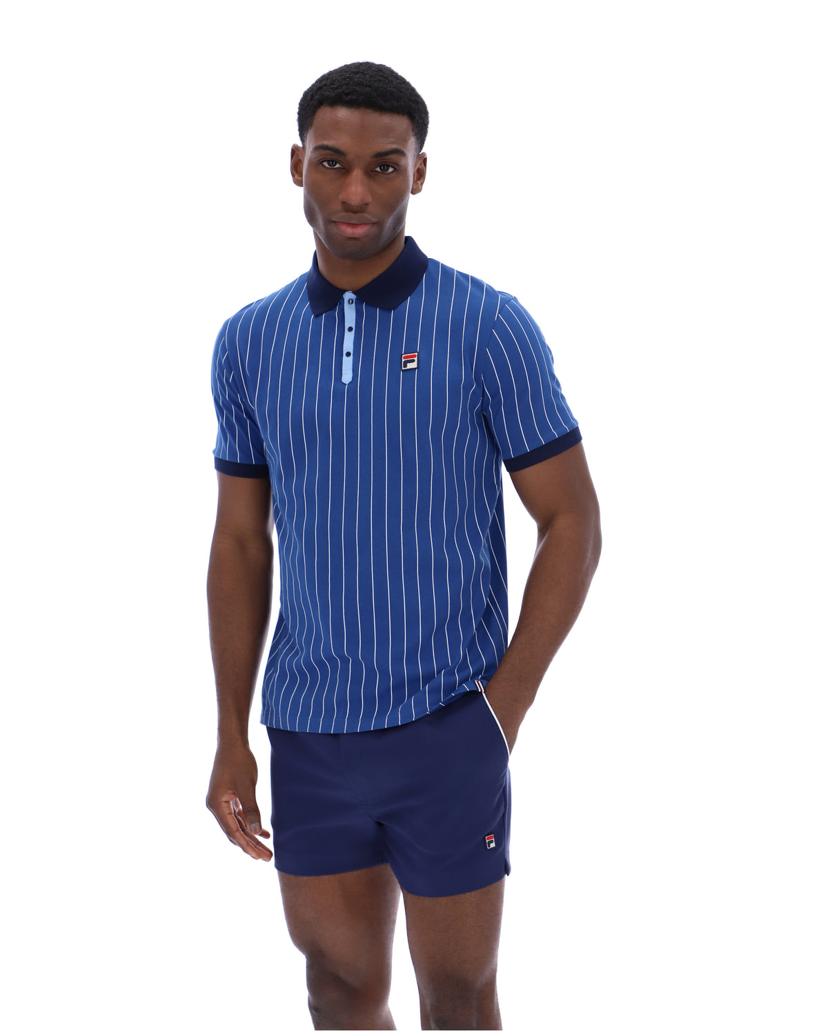 Man wearing a blue striped polo shirt and shorts with a brand logo on a white background