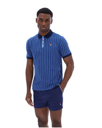 Man wearing a blue striped polo shirt and shorts with a brand logo on a white background