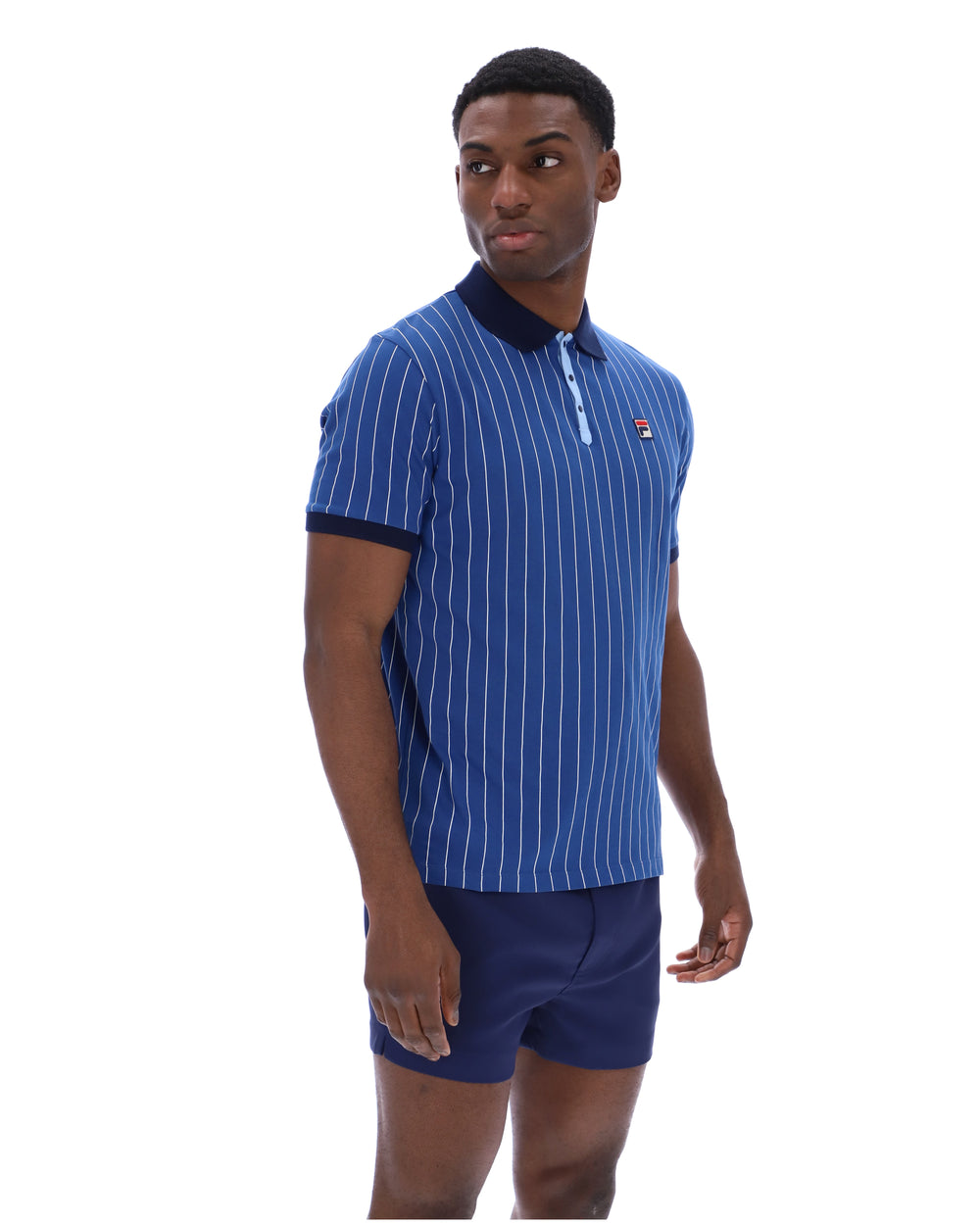 Man wearing a blue striped polo shirt and shorts on a white background
