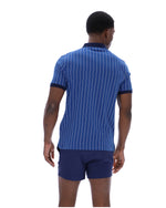 Man wearing a blue pinstripe polo shirt and matching shorts on a white background
