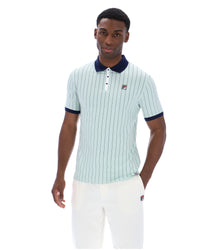 Man wearing a light blue striped polo shirt with dark collar and trim on a white background