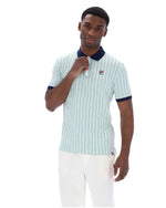 Man wearing a light blue striped polo shirt with dark collar and trim on a white background