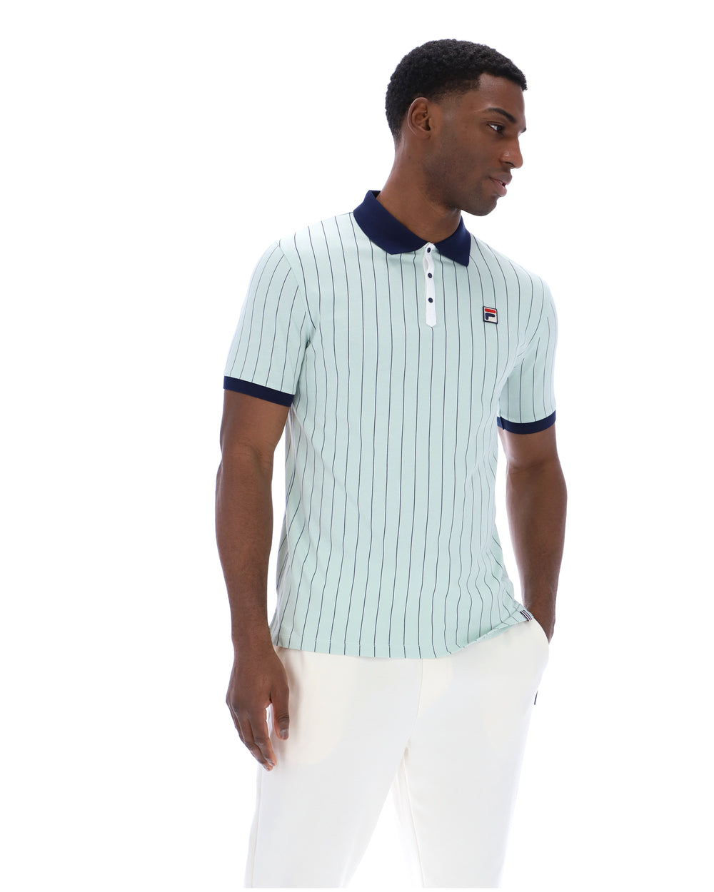 Man wearing a light blue striped polo shirt with a dark collar on a white background