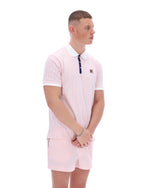 Man wearing a pink striped polo shirt and shorts on a white background