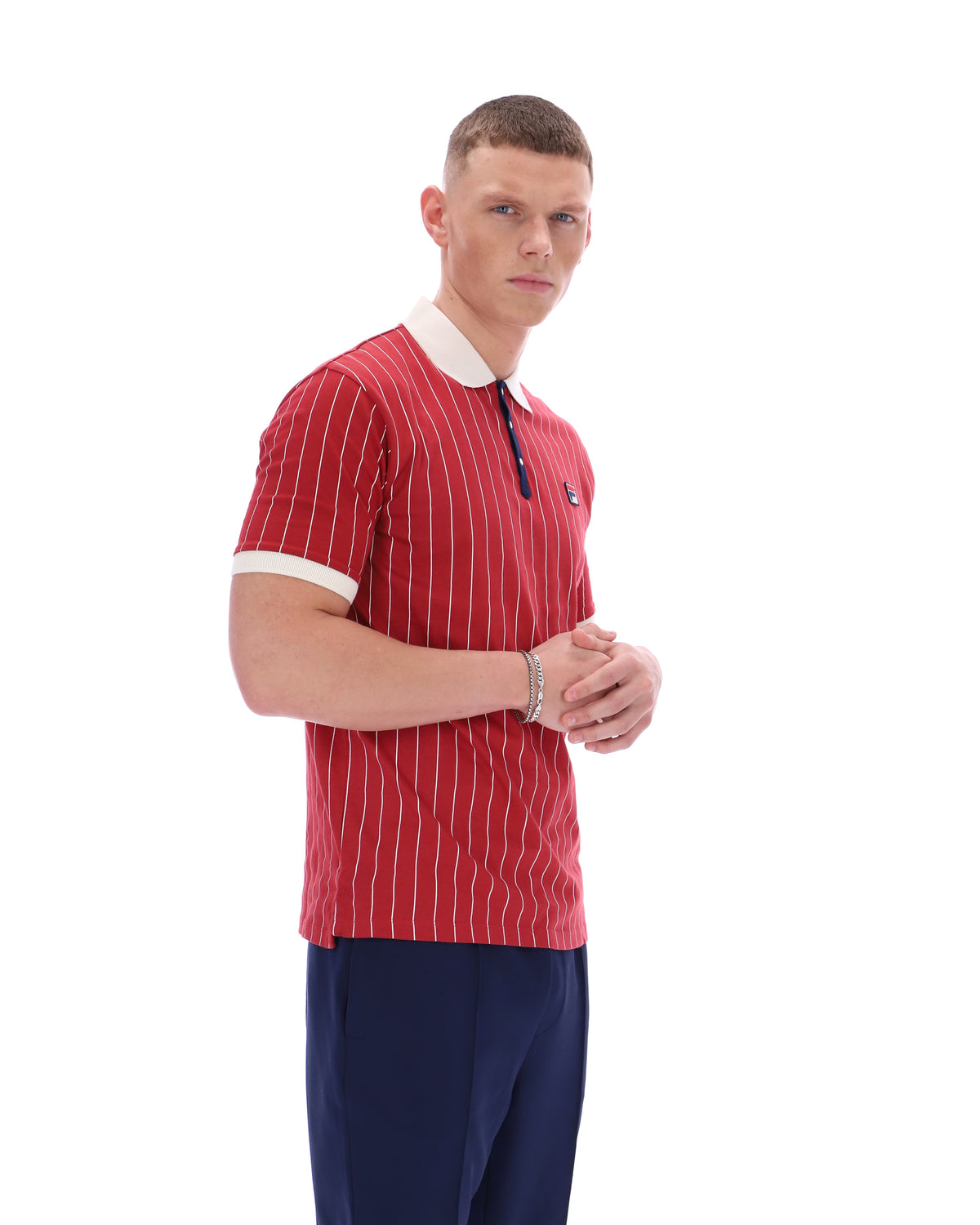 Man wearing a red striped polo shirt with a white collar on a white background