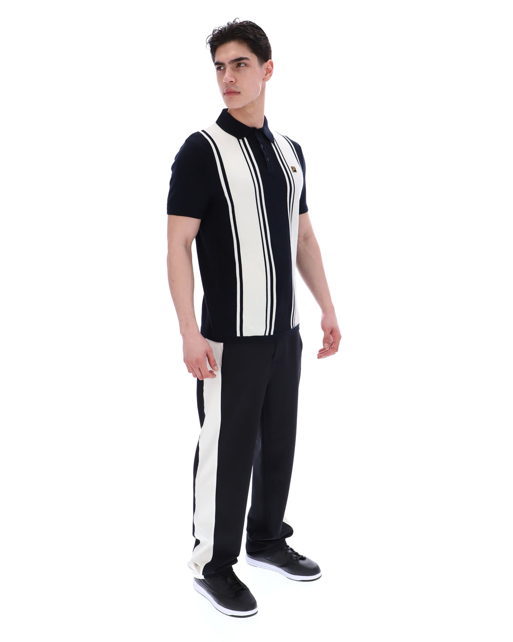 Man wearing a black and white striped outfit on a white background