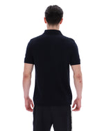 Man wearing a black polo shirt on a white background