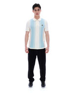 Man wearing a white polo shirt with blue stripes and black pants on a white background