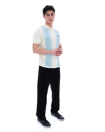 Man wearing a white polo shirt with blue stripes and black pants on a white background