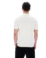 Man wearing a white polo shirt on a white background
