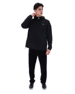 Person wearing a black tracksuit on a white background