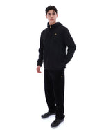 Person wearing a black hoodie and pants with a brand logo on a white background