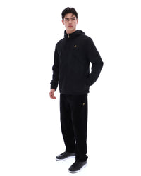 Person wearing a black hoodie and pants with a brand logo on a white background