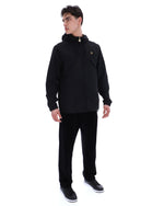 Man wearing a black hoodie and pants on a white background