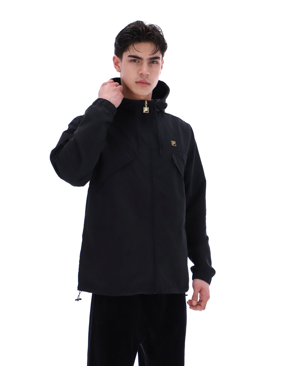 Person wearing a black jacket with a brand logo on a white background