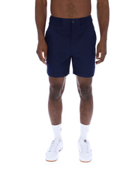 Displays a model wearing the Navy 'Fila' Caruso Chino Shorts