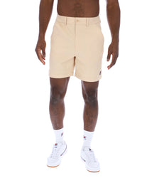 Displays a model wearing the Classic Beige 'FILA' branded Caruso Chino Shorts