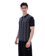 Man wearing a black and grey patterned shirt on a white background