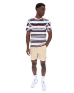 Man wearing a striped shirt and beige shorts on a white background