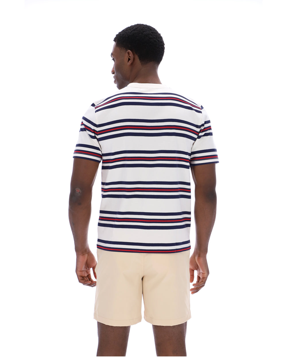 Man wearing a striped polo shirt and beige shorts on a white background