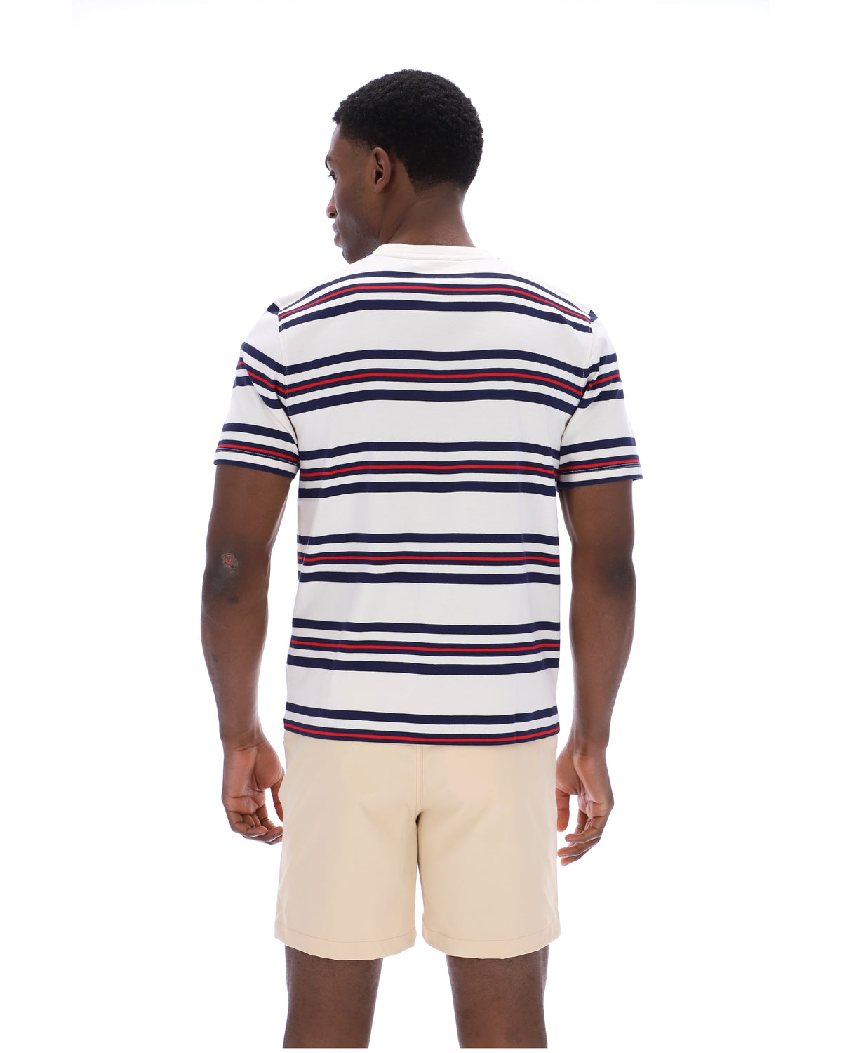 Man wearing a striped polo shirt and beige shorts on a white background