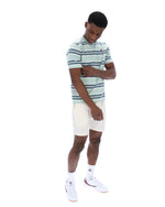 Man wearing a striped polo shirt and white shorts on a white background