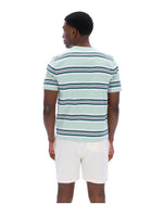 Man wearing a light blue and white striped polo shirt on a white background