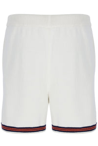 White shorts with red and blue trim on a white background