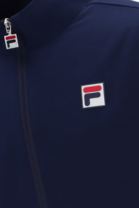 A navy blue tennis track top with zip up fastening, featuring the British flag and the FILA logo on the chest.