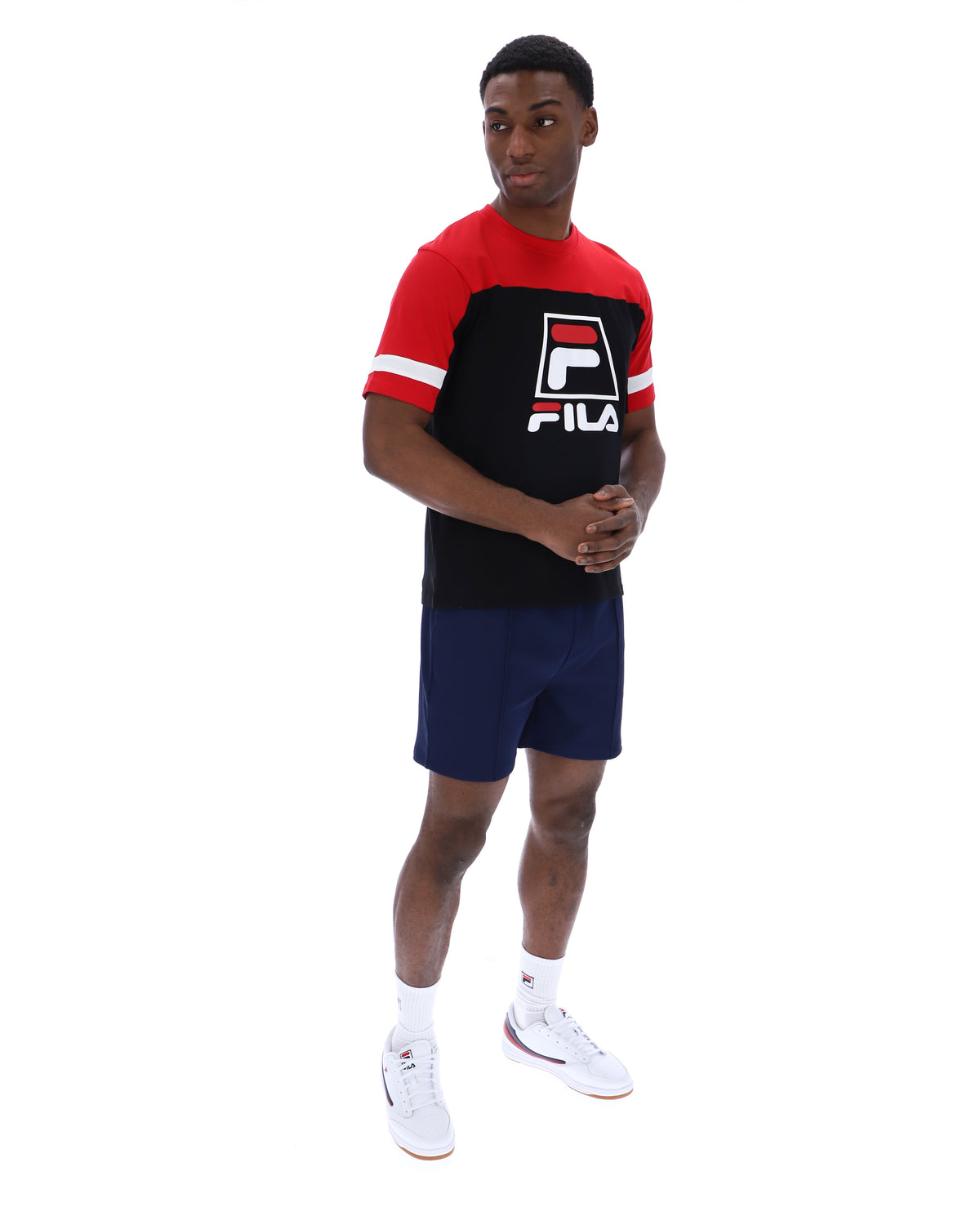 Displays a model wearing the Black 'Fila' branded Damon Cut and Sew Tee